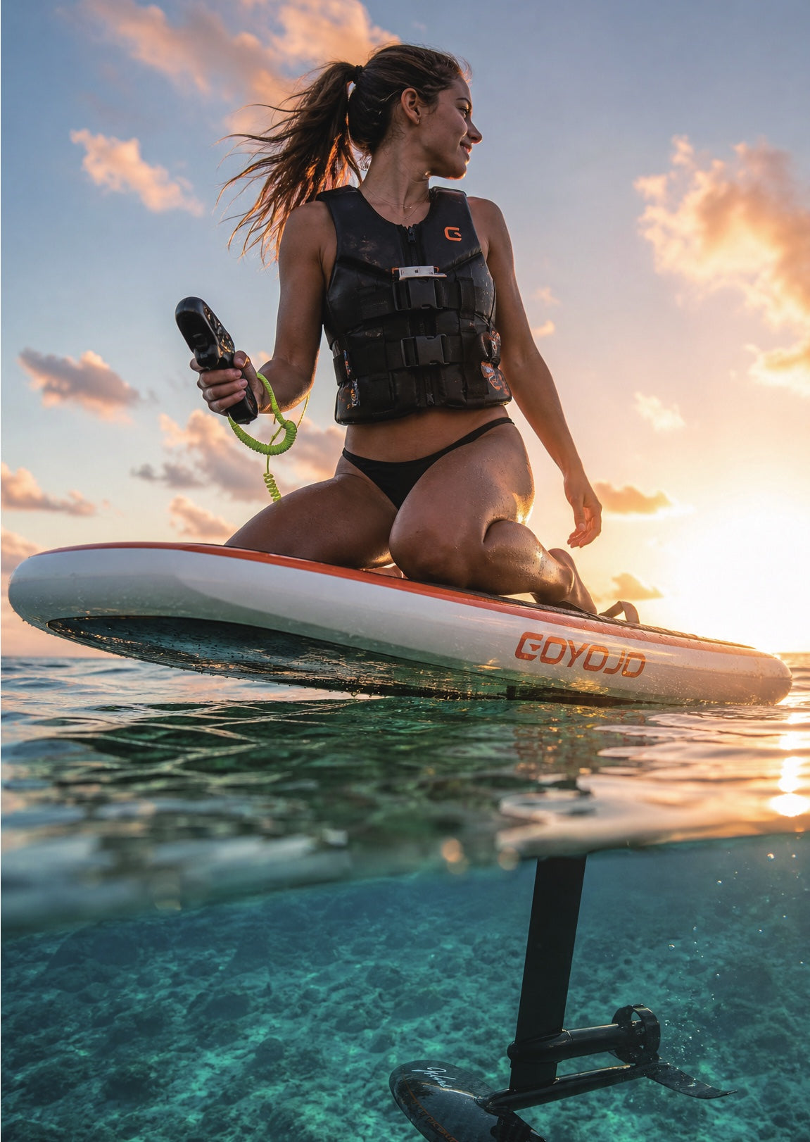 Rider resting on an electric hydrofoil board at sunset